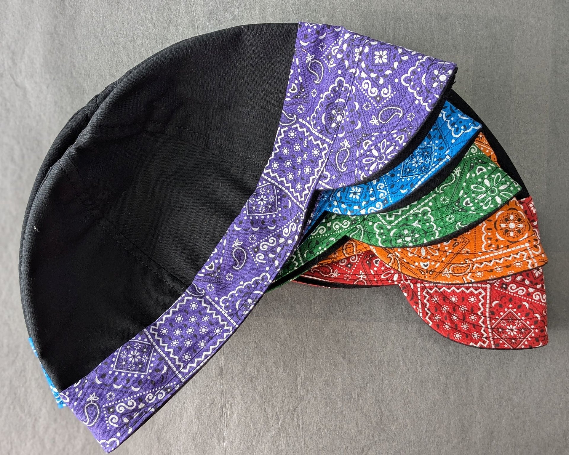 Five Bandanna 2 Tone welding caps in Black with purle, blue, green, orange and red bandanna prints