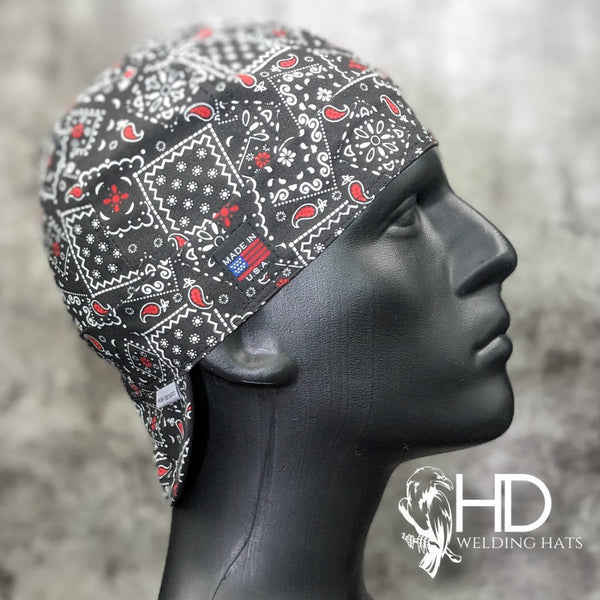 Side view of the Black & Red Bandanna Welding Cap featuring a black cotton fabric with red and white paisley bandanna pattern — handcrafted by HD Welding Hats.