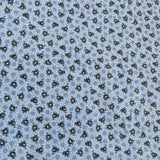 Close-up of the Blue Calico Welding Cap fabric featuring small black floral designs on a blue background — handcrafted by HD Welding Hats.