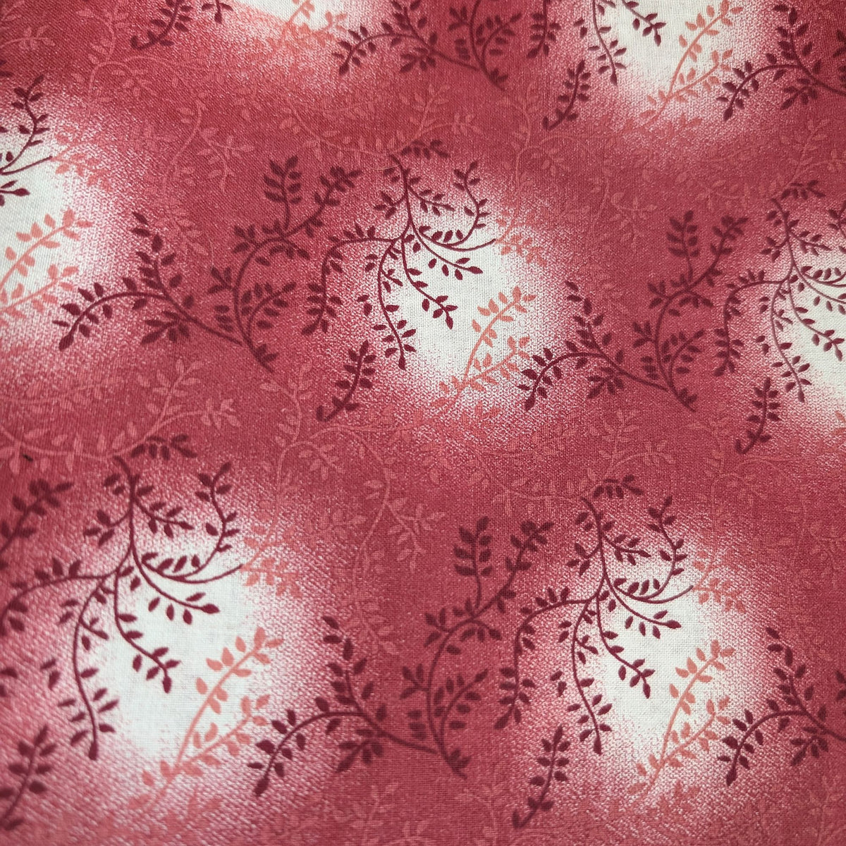 Burgundy Calico Welding Cap fabric with vine-style floral pattern in shades of burgundy and rose red on white, handcrafted from preshrunk cotton.