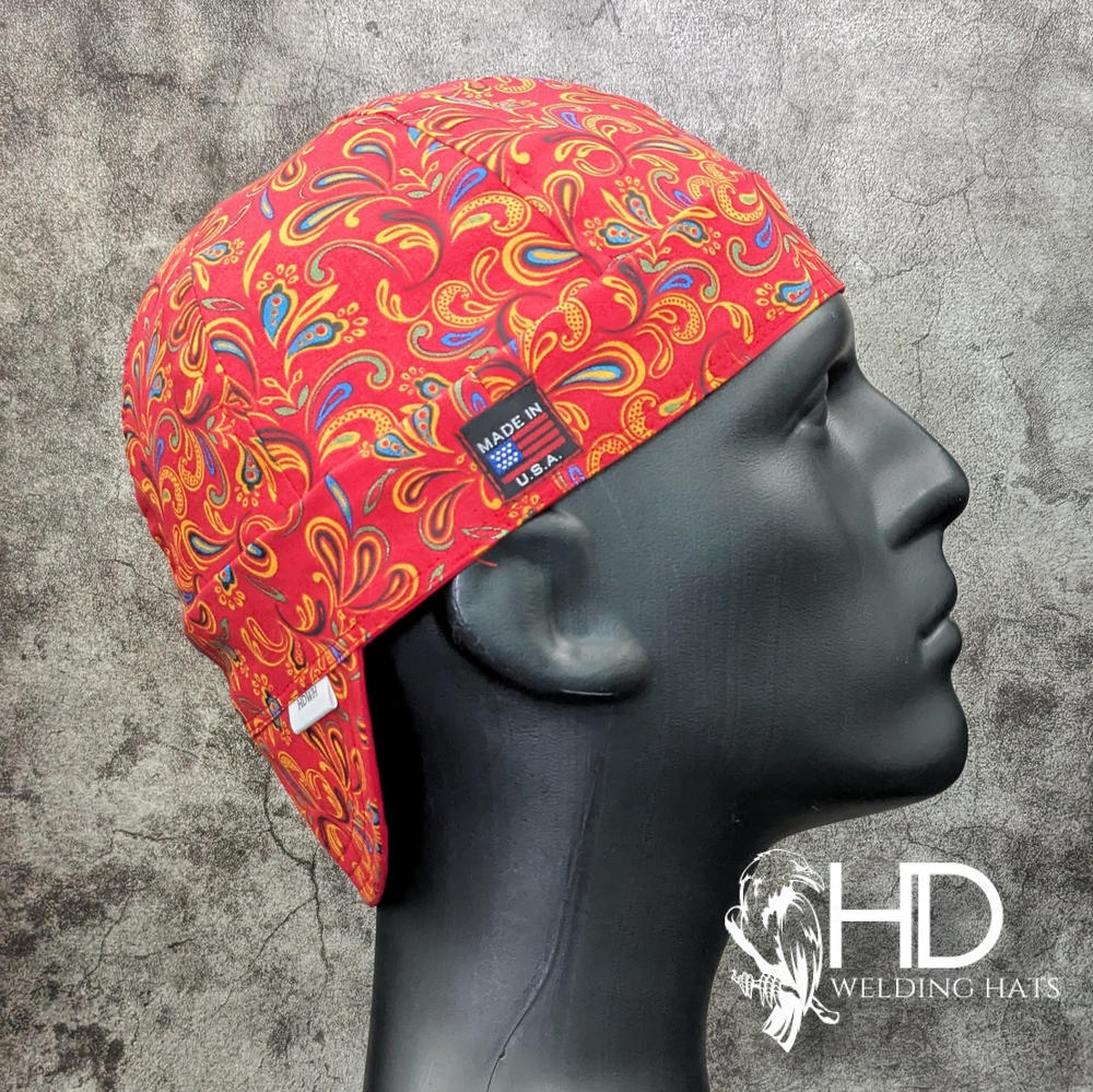 Frontier Paisley Fiesta Welding Cap – red cotton welding hat with yellow, blue, and orange paisley print and FR denim brim, handmade in the USA by HD Welding Hats.