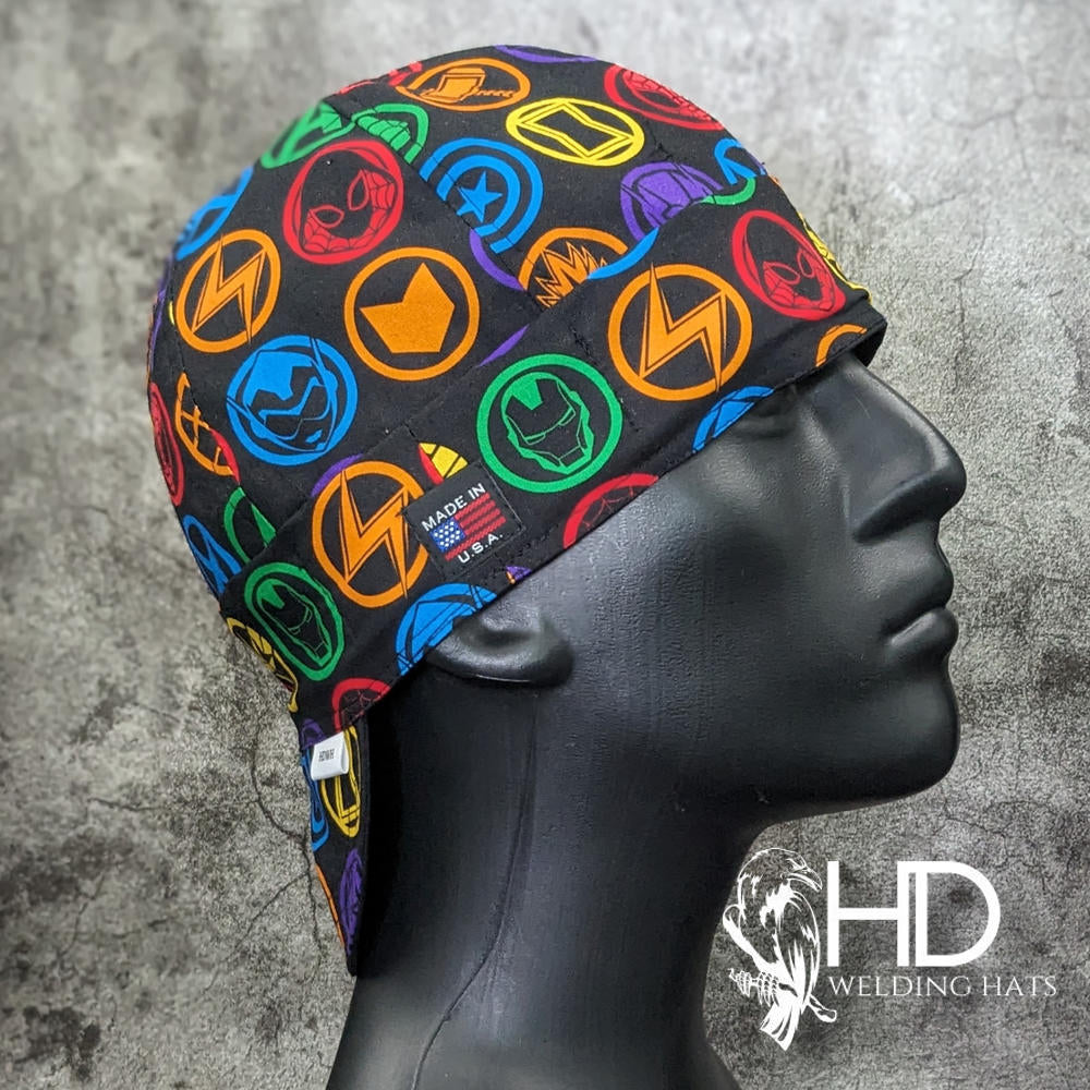 Marvel Badge Welding Cap with colorful superhero emblems on black cotton, handmade in the USA by HD Welding Hats with FR denim brim.