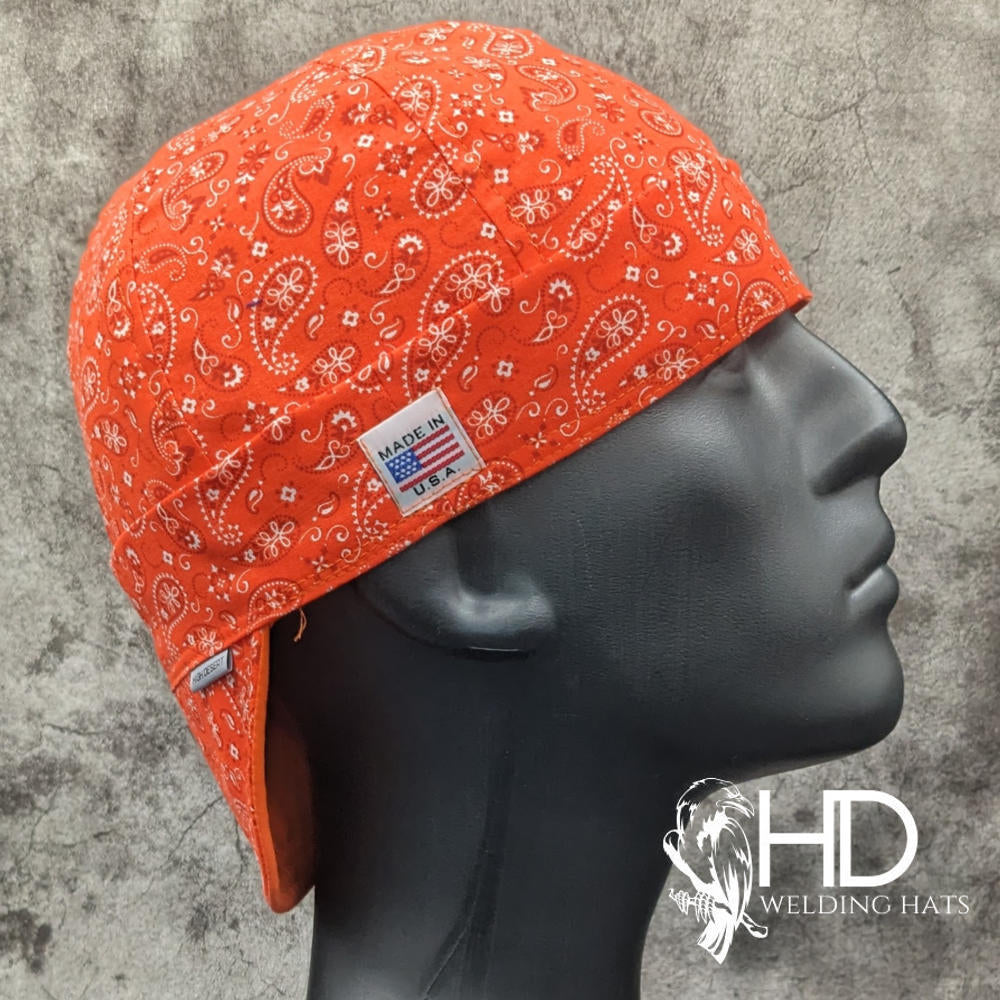 Orange Paisley Bandanna Welding Cap with bright orange cotton and classic white paisley print, handmade in the USA by HD Welding Hats.