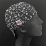 Side view of the Black Daisy Welding Cap featuring a white daisy outline pattern on black cotton fabric — handcrafted by HD Welding Hats.