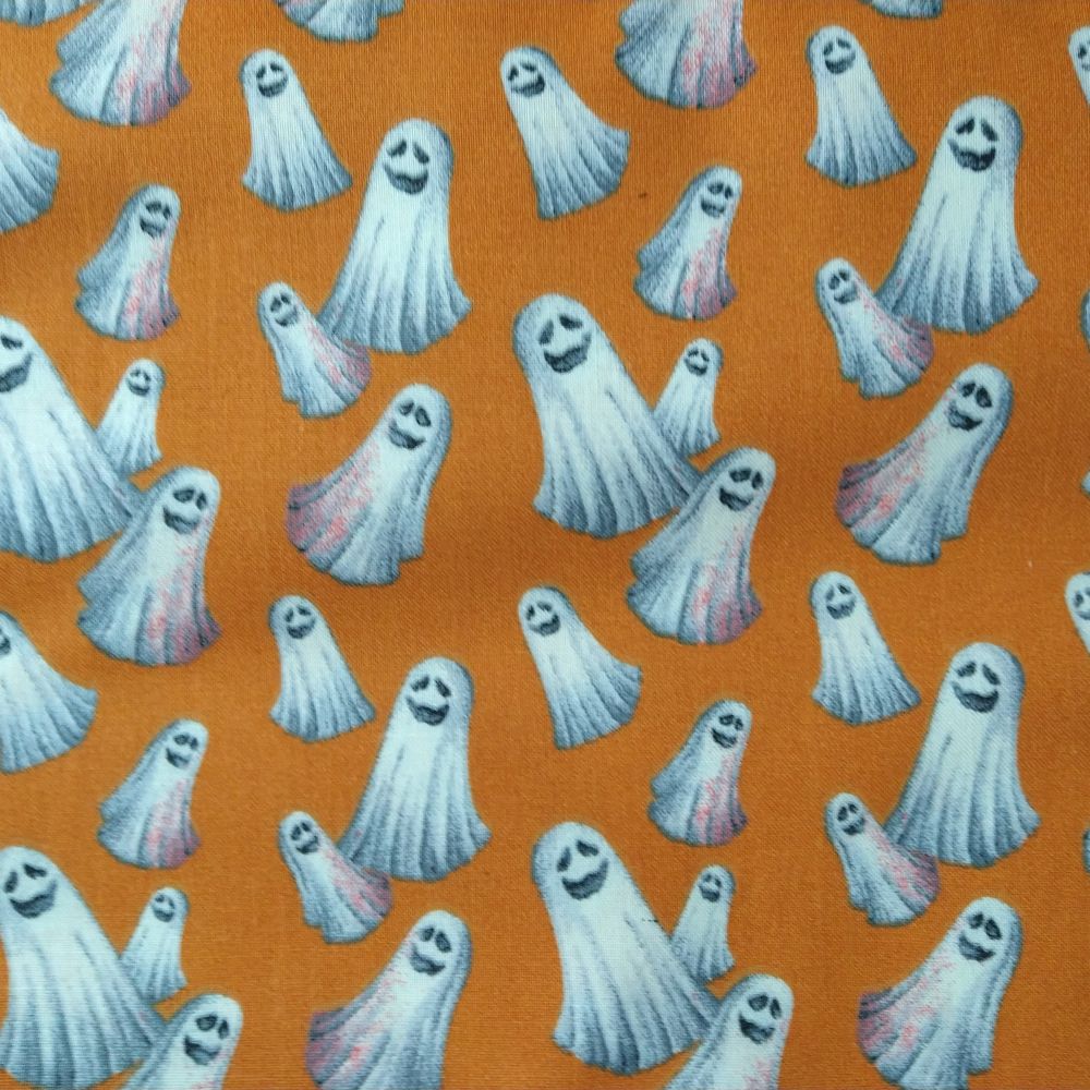 Close-up of the Boris Welding Cap fabric featuring smiling white ghosts on a bright orange background — handcrafted by HD Welding Hats.