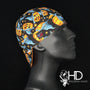 Side view of the Autumn Gold Welding Cap with jack-o’-lanterns, blue ghosts, and stars on black cotton — handcrafted by HD Welding Hats.