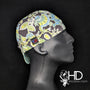 Jacobean Welding Cap with blue, green, and yellow floral pattern on charcoal background, FR denim brim, and Made in USA label by HD Welding Hats.
