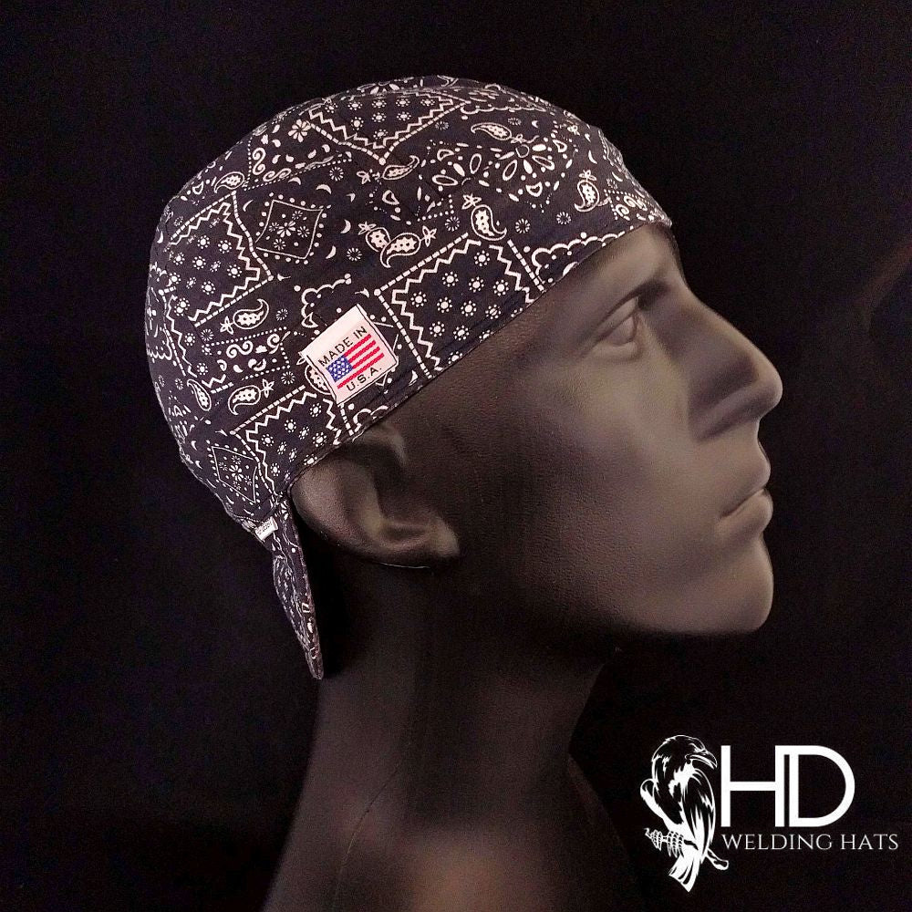 Side view of the Black Bandanna Welding Cap featuring a white paisley print on black cotton fabric — handcrafted by HD Welding Hats.