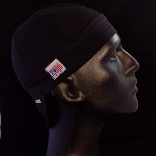 Side view of the Black Cotton Welding Cap featuring solid black cotton fabric and a Made in USA tag — handcrafted by HD Welding Hats.