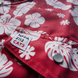 Red fabric with white floral patterns and NFPA 2112 CAT2 label.
