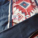 Close-up of a label on a denim shirt with a geometric pattern