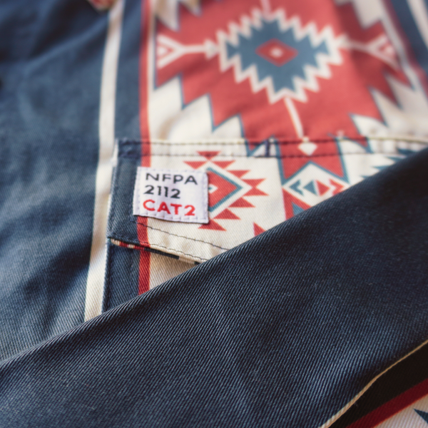 Close-up of a label on a denim shirt with a geometric pattern