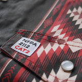 Close-up of a label on a garment with NFPA 2112 CAT2 text on a patterned fabric background.