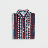 Patterned shirt with red, blue, and white design on a light gray background