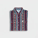Patterned shirt with red, blue, and white design on a light gray background