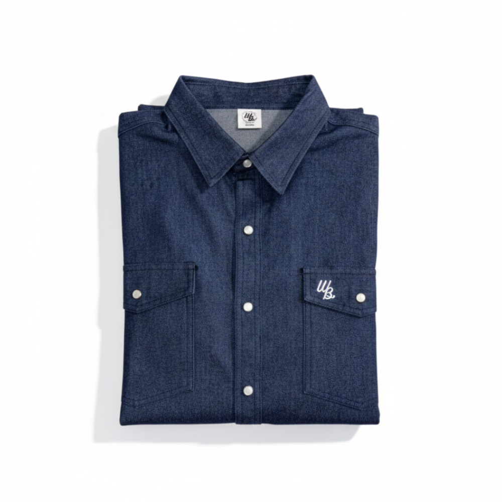 Folded blue denim shirt with white buttons on a white background