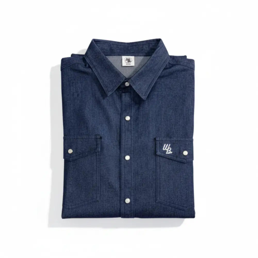 Folded blue denim shirt with white buttons on a white background