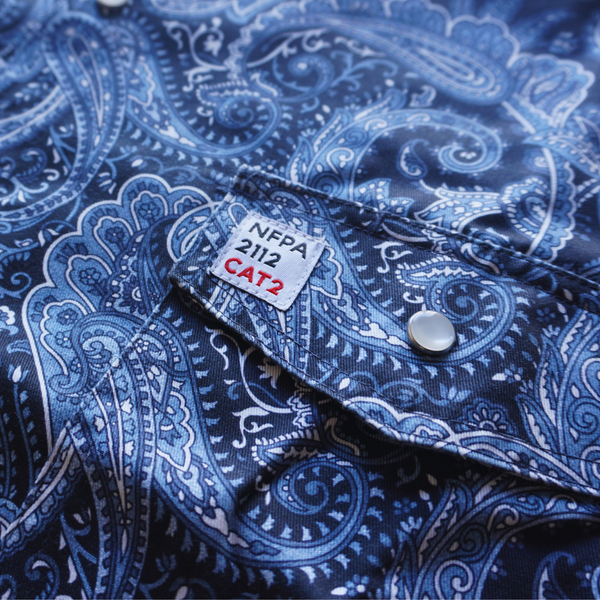 Blue paisley patterned shirt with NFPA 2112 CAT2 label on collar