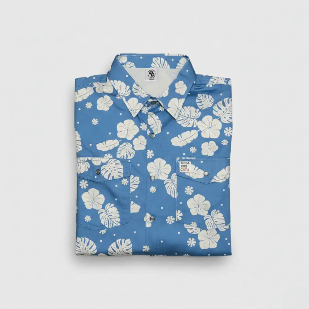 Folded blue shirt with white floral pattern on a light gray background