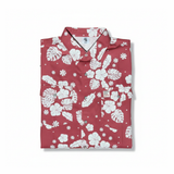 Folded red shirt with white floral pattern on a white background