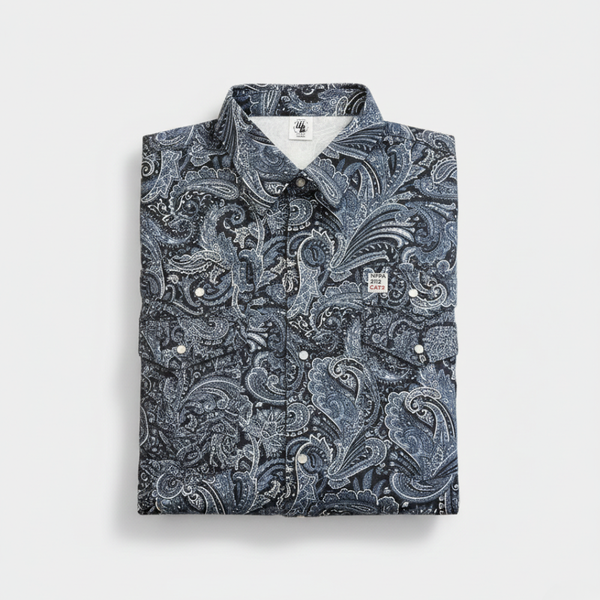 Folded shirt with a blue paisley pattern on a light gray background