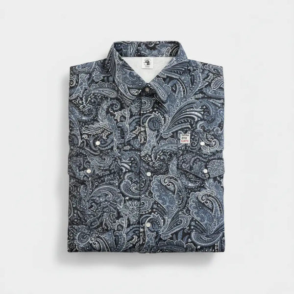 Folded shirt with a blue paisley pattern on a light gray background
