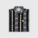 Folded patterned shirt with visible brand logo on a light gray background