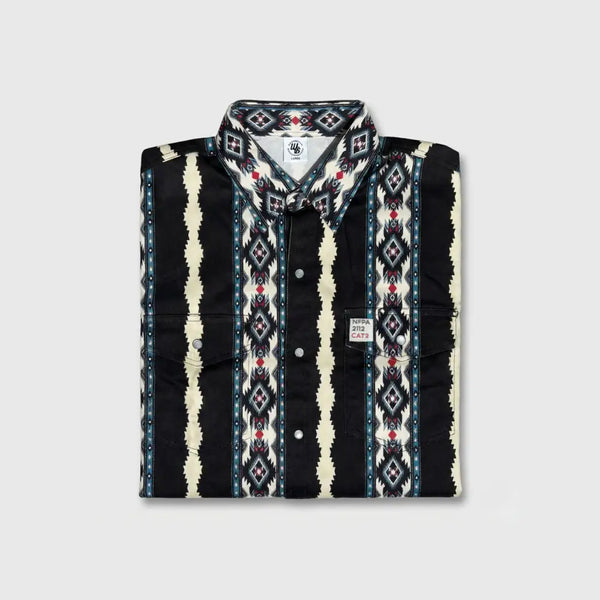 Folded patterned shirt with visible brand logo on a light gray background