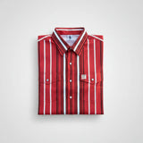 Folded red and white striped shirt on a light gray background