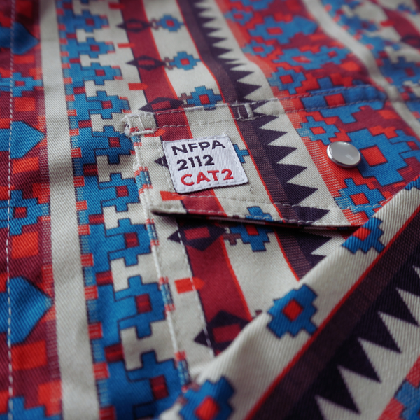 Colorful patterned fabric with a NFPA 2112 CAT2 label.