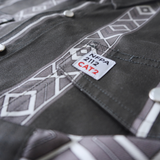 Close-up of a gray work shirt with NFPA 2112 CAT2 label