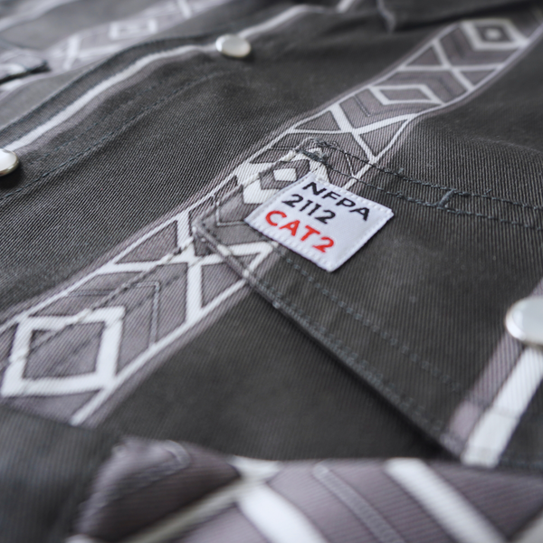 Close-up of a gray work shirt with NFPA 2112 CAT2 label