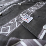 Close-up of a gray work shirt with NFPA 2112 CAT2 label