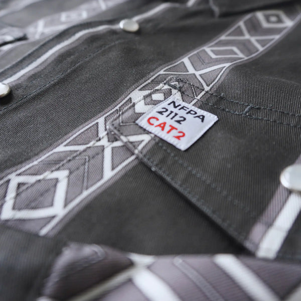 Close-up of a gray work shirt with NFPA 2112 CAT2 label
